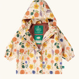 Little Green Radicals flower meadow recycled waterproof kids raincoat. A mix of different flowers on a Light cream background