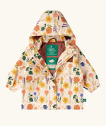 Little Green Radicals flower meadow recycled waterproof kids raincoat. A mix of different flowers on a Light cream background