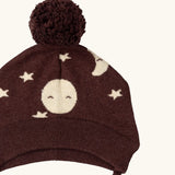 Close up of the bobble on the Little Green Radicals brown organic cotton moon knitted bobble hat with chin strap ties.