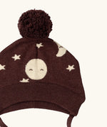 Close up of the bobble on the Little Green Radicals brown organic cotton moon knitted bobble hat with chin strap ties.