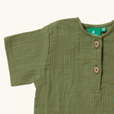 Close up of the button closure on the neckline of the Little Green Radicals Muslin Loose Fit Short Sleeve Henley Top in a Chive Green colour.
