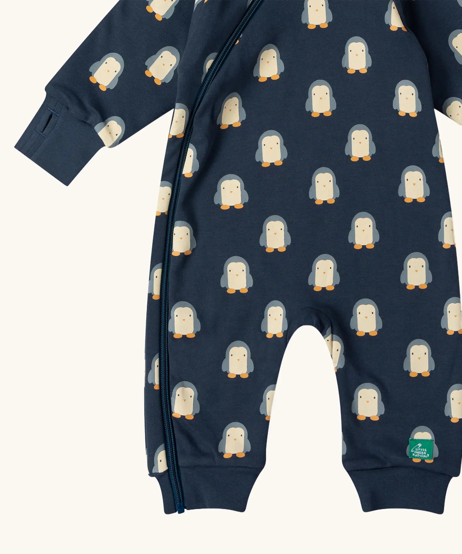 Close up of the Little Green Radicals navy blue penguins hooded reversible snug suit showing the zip opening down the leg.