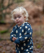 Child wearing a Little Green Radicals navy blue penguins hooded reversible snug suit.