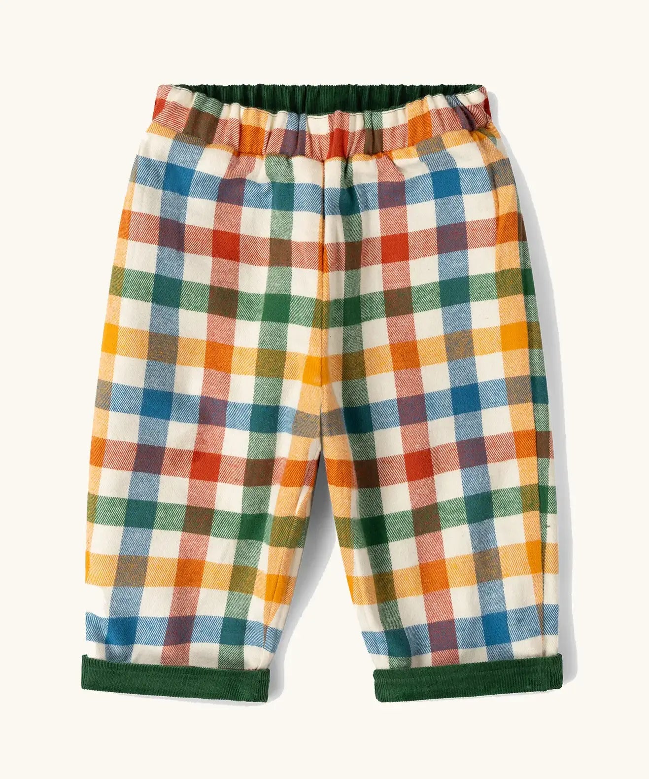 Little Green Radicals olive green organic cotton reversible pull on trousers shown on multi coloured check side. 