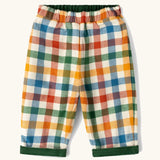 Little Green Radicals olive green organic cotton reversible pull on trousers shown on multi coloured check side. 