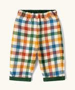 Little Green Radicals olive green organic cotton reversible pull on trousers shown on multi coloured check side. 