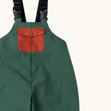 Close up of the rust orange pocket on the front of the Little Green Radicals olive green recycled lined waterproof dungarees