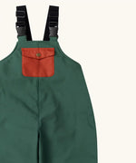 Close up of the rust orange pocket on the front of the Little Green Radicals olive green recycled lined waterproof dungarees