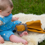 A baby playing with the Little Green Radicals Golden yellow Lion Organic Cotton Baby Comforter Toy.