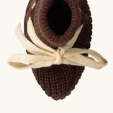 Overhead view of the Little Green Radicals hazelnut brown organic cotton knitted baby booties.