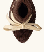 Overhead view of the Little Green Radicals hazelnut brown organic cotton knitted baby booties.