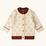 Little Green Radicals organic cotton knitted cardigan with snow penguins design. Natural cream cardigan with penguins all over, maroon trim on the collar and hem line.