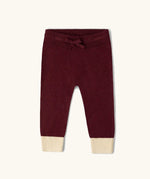 Little Green Radicals organic cotton knitted joggers in a winter berry colour.