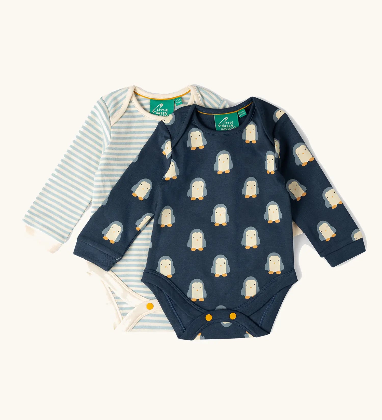 Little Green Radicals organic cotton long-sleeve baby bodysuits 2 pack , one navy with all over penguin print, one blue and white stripes.