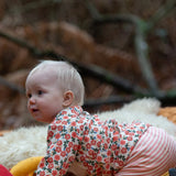 Baby wearing the Little Green Radicals organic cotton long sleeve top and jogger playset with pink petals flowers design.