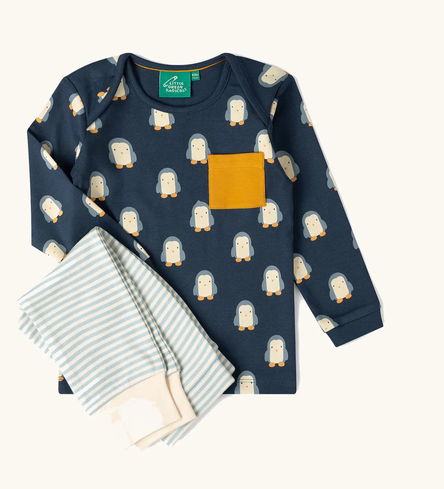  Little green Radicals blue penguin design playset outfit. Long sleeved organic cotton top in navy with penguins all over and light blue and white striped joggers.