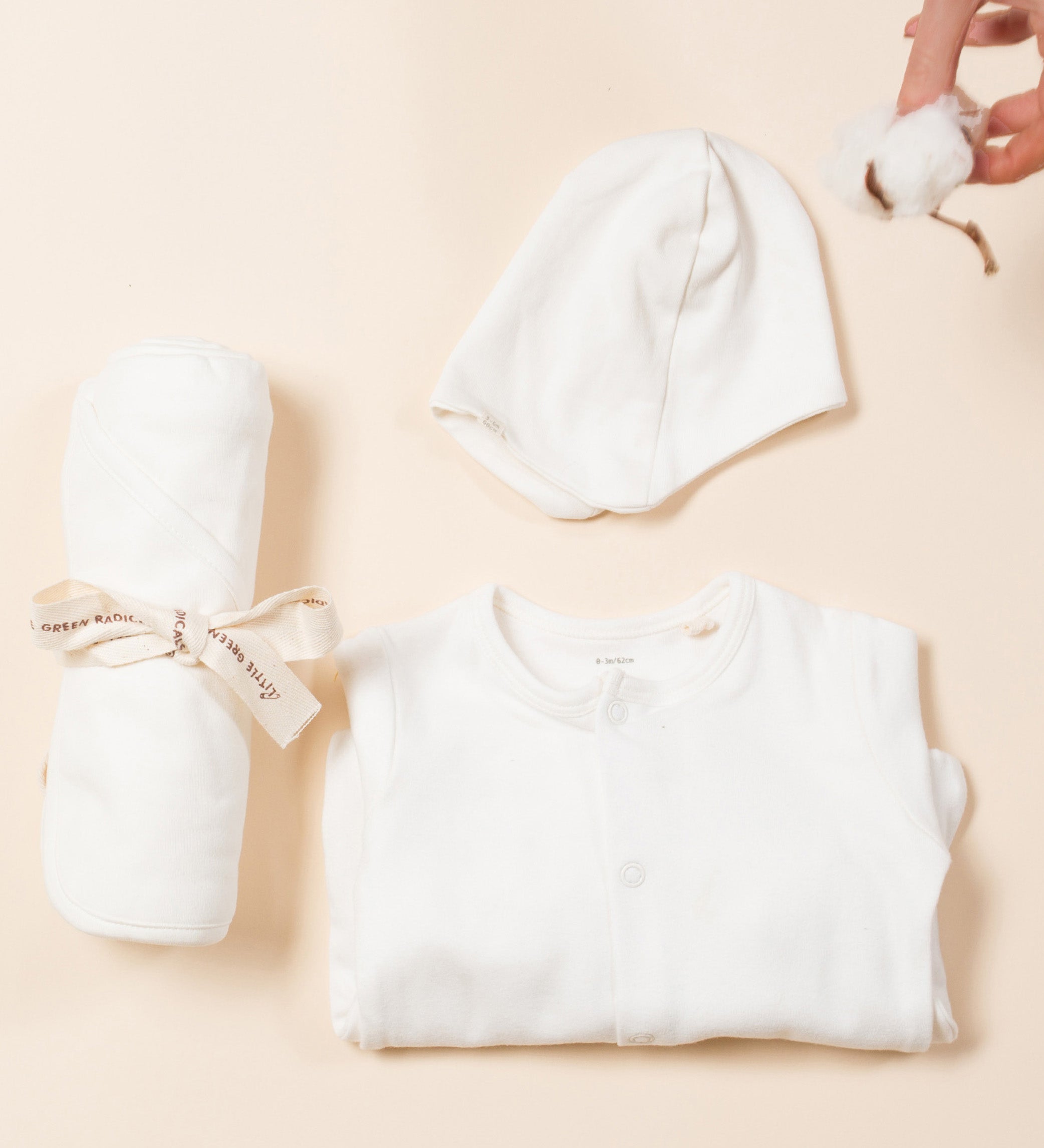 The Little Green Radicals newborn baby giftset, including GOTS certified organic cotton babygrow, hat, and hooded blanket. 