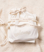 The lovely organic cotton gift bag that comes with the Little Green Radicals newborn baby giftset, with 'welcome' embroidered on the front. 
