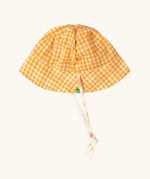 Little Green Radicals organic cotton reversible sunhat on the yellow gold and white gingham print side. 