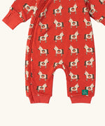 Close up of the front of the Little Green Radicals pink unicorns organic cotton reversible snug suit. One side is pink with a repeat unicorns print, the other is light pink and white striped. 