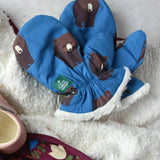 Little Green Radicals Organic Cotton Sherpa-Lined Children's bear print mittens placed on a sherpa lined blanket.