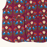 Close up of the pockets on the front of the Little Green Radicals folk birds organic cotton sherpa fleece reversible gilet. Purple gilet with repeal all over Folk Birds print on one side and sherpa fleece on the other.
