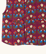 Close up of the pockets on the front of the Little Green Radicals folk birds organic cotton sherpa fleece reversible gilet. Purple gilet with repeal all over Folk Birds print on one side and sherpa fleece on the other.