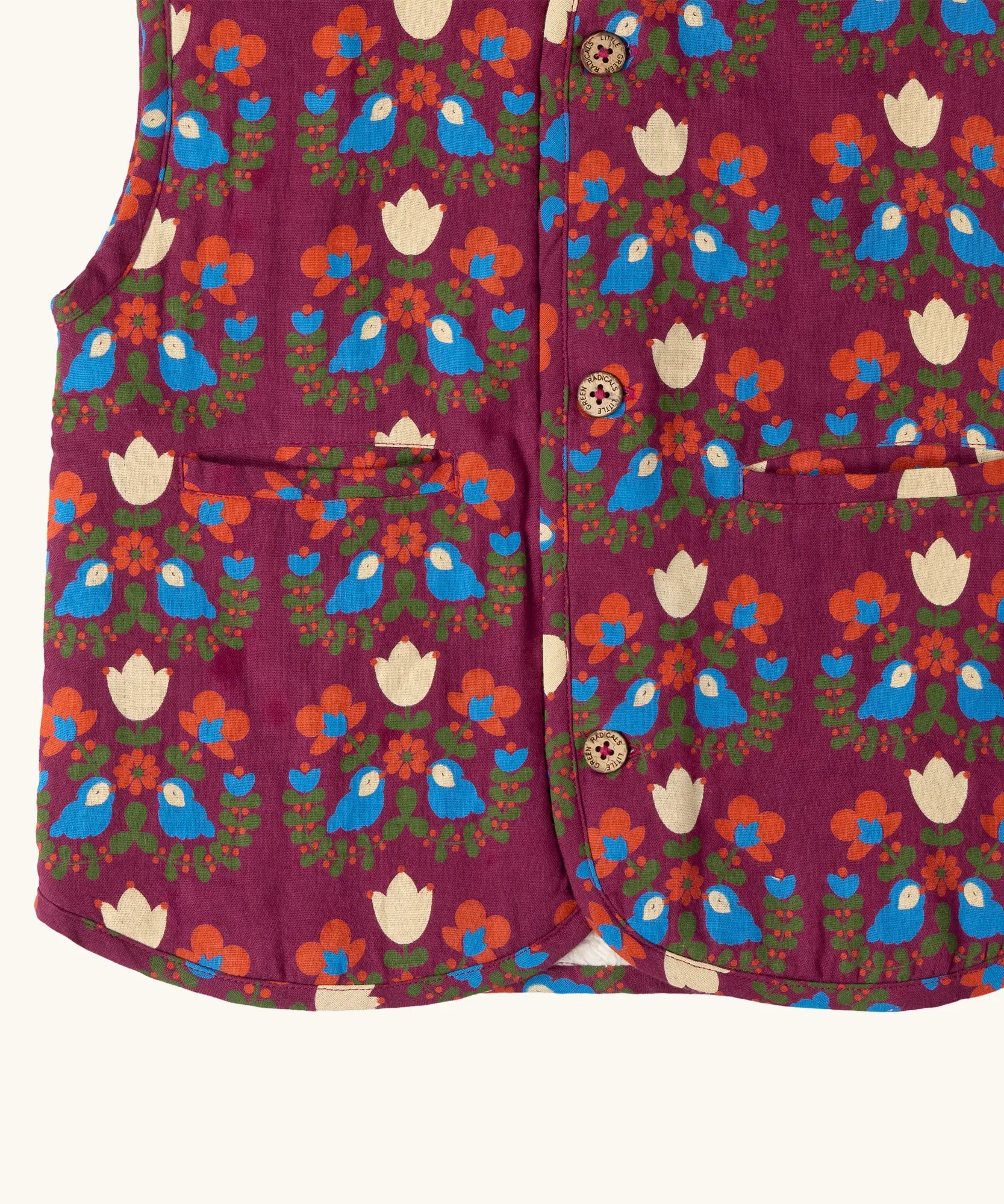 Close up of the pockets on the front of the Little Green Radicals folk birds organic cotton sherpa fleece reversible gilet. Purple gilet with repeal all over Folk Birds print on one side and sherpa fleece on the other.
