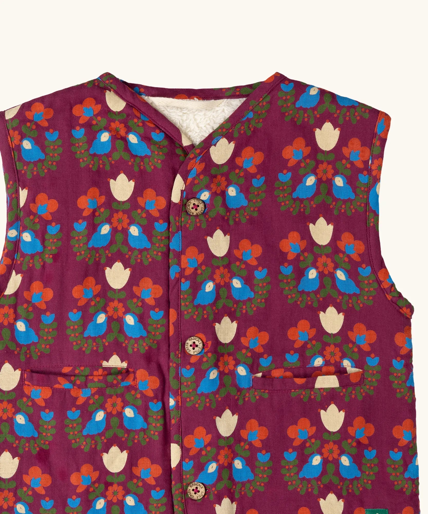 Close up of the print on the Little Green Radicals folk birds organic cotton sherpa fleece reversible gilet. Purple gilet with repeal all over Folk Birds print on one side and sherpa fleece on the other.