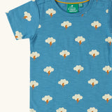 Close up of the Little Green Radicals blue all weather repeat print organic cotton short sleeve t-shirt.