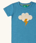 Close up of the white cloud with yellow lightning strike on the front of the Little Green Radicals every cloud short sleeved blue organic cotton t-shirt. 