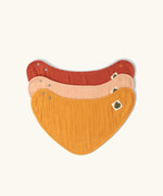 Little Green Radicals coral pink organic muslin bib set. Gold ochre yellow, red rust, and coral pink bandana style bibs in a pack of three.