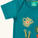 Close up of the short sleeve on the Little Green Radicals Spring garden embroidered organic cotton green t-shirt. 