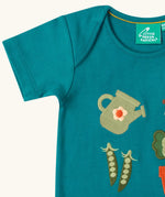Close up of the short sleeve on the Little Green Radicals Spring garden embroidered organic cotton green t-shirt. 