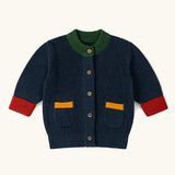 Little Green Radicals children's organic cotton snuggly knitted cardigan in midnight blue with green collar and red arm cuffs.