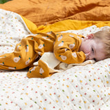 Little Green Radicals summer pears repeat print zip organic cotton footed babygrow on a baby.