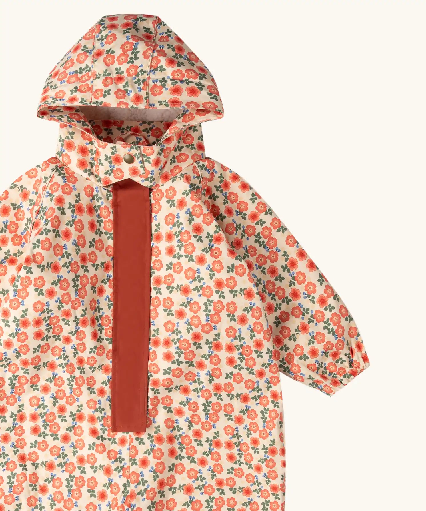 Close up of the Little Green Radicals petals recycled waterproof winter suit. Light background with pink repeat al over flower print. 
