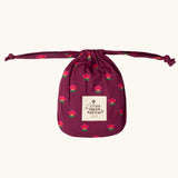 Storage bag that the Little Green Radicals pink flowers print organic cotton classic purple pyjamas come inside. 