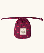 Storage bag that the Little Green Radicals pink flowers print organic cotton classic purple pyjamas come inside. 