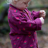 Child wearing the Little Green Radicals pink flowers organic cotton classic pyjamas.