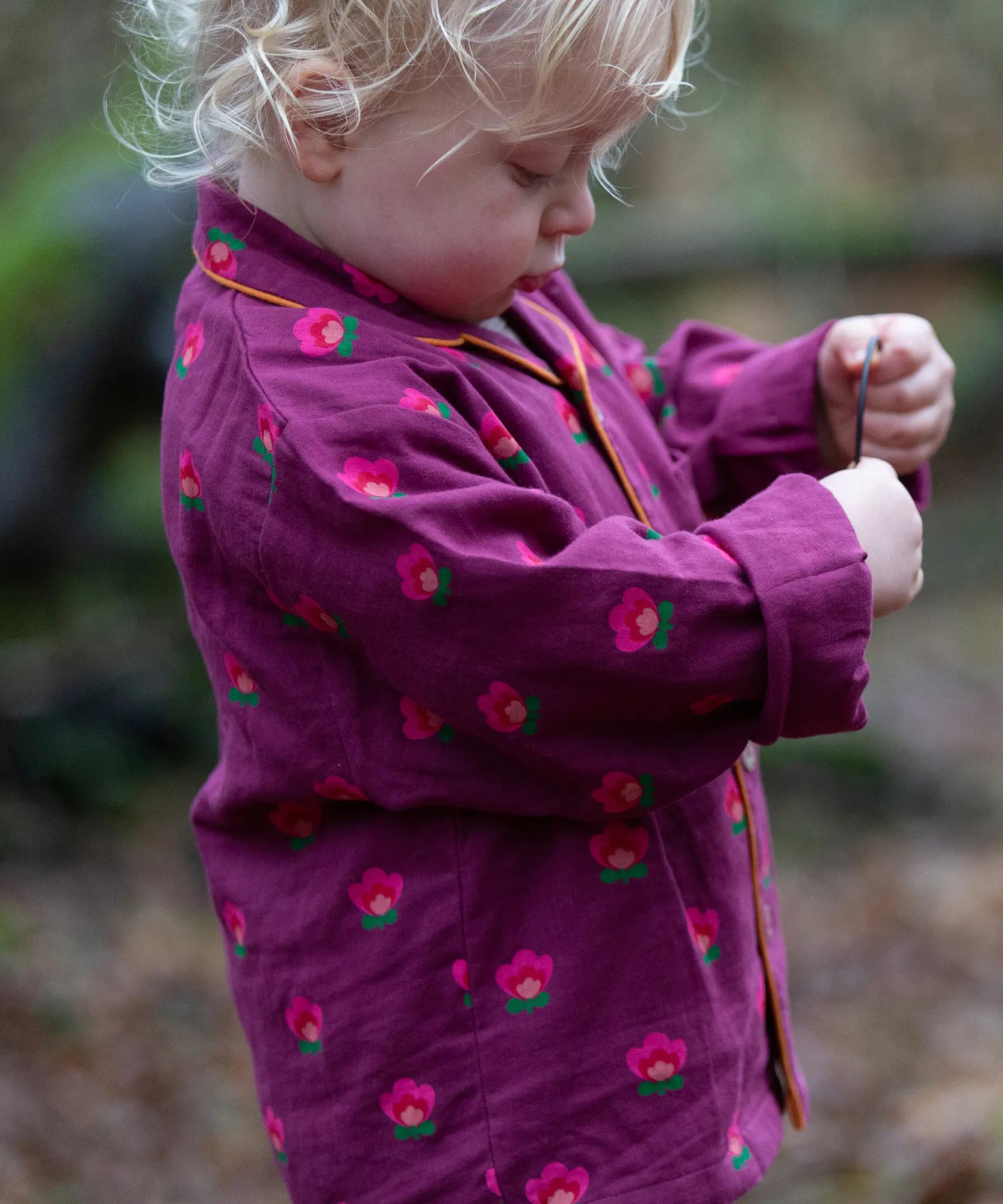 Child wearing the Little Green Radicals pink flowers organic cotton classic pyjamas.