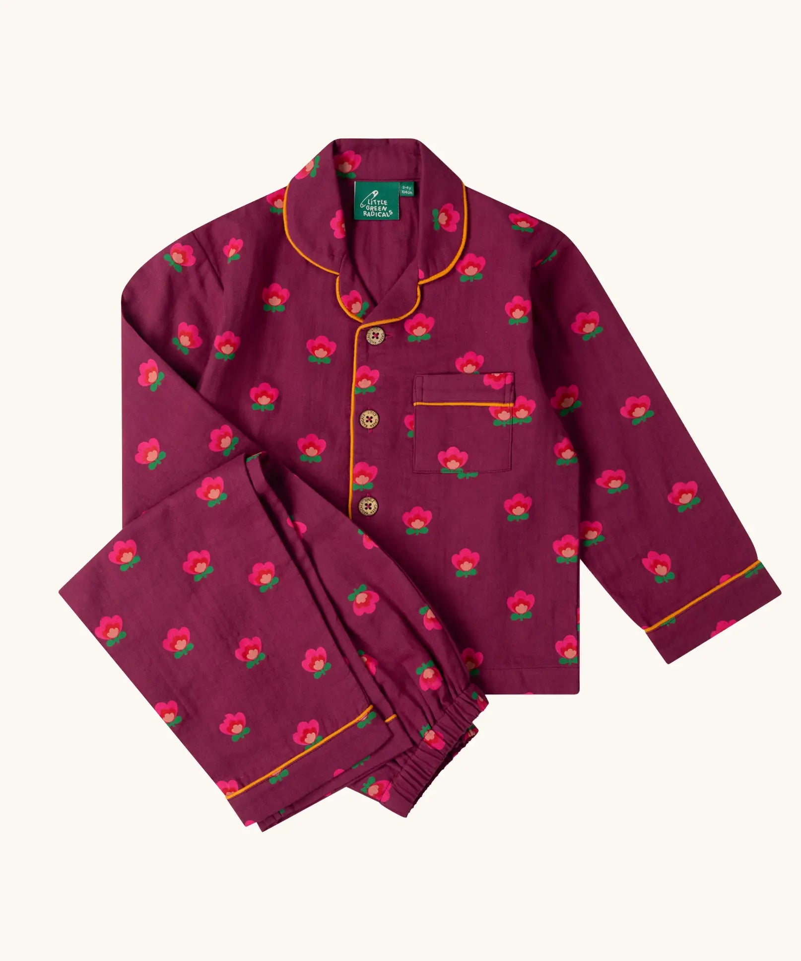 Little Green Radicals pink flowers print organic cotton classic purple pyjamas. Long sleeve button up top with matching trousers.