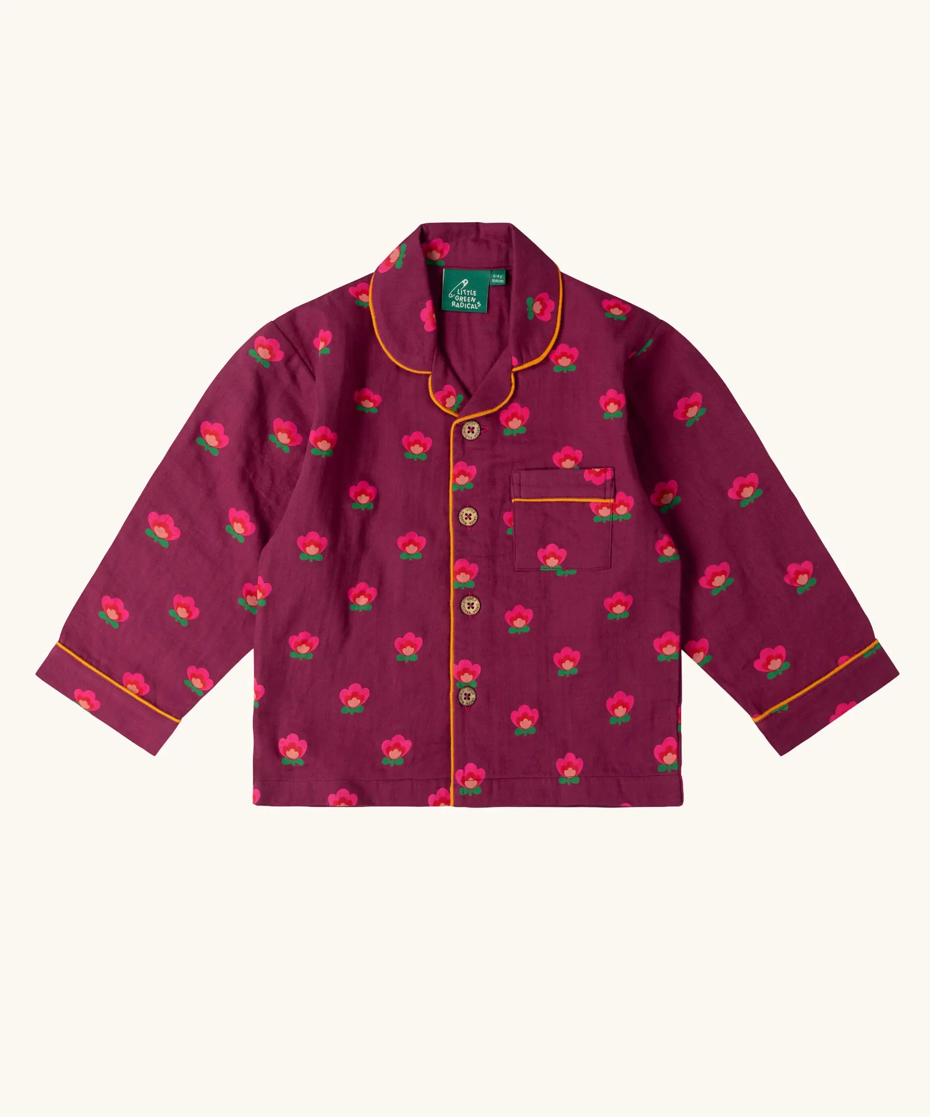 Top from the Little Green Radicals pink flowers print organic cotton classic purple pyjamas. Long sleeve button up top with matching trousers.