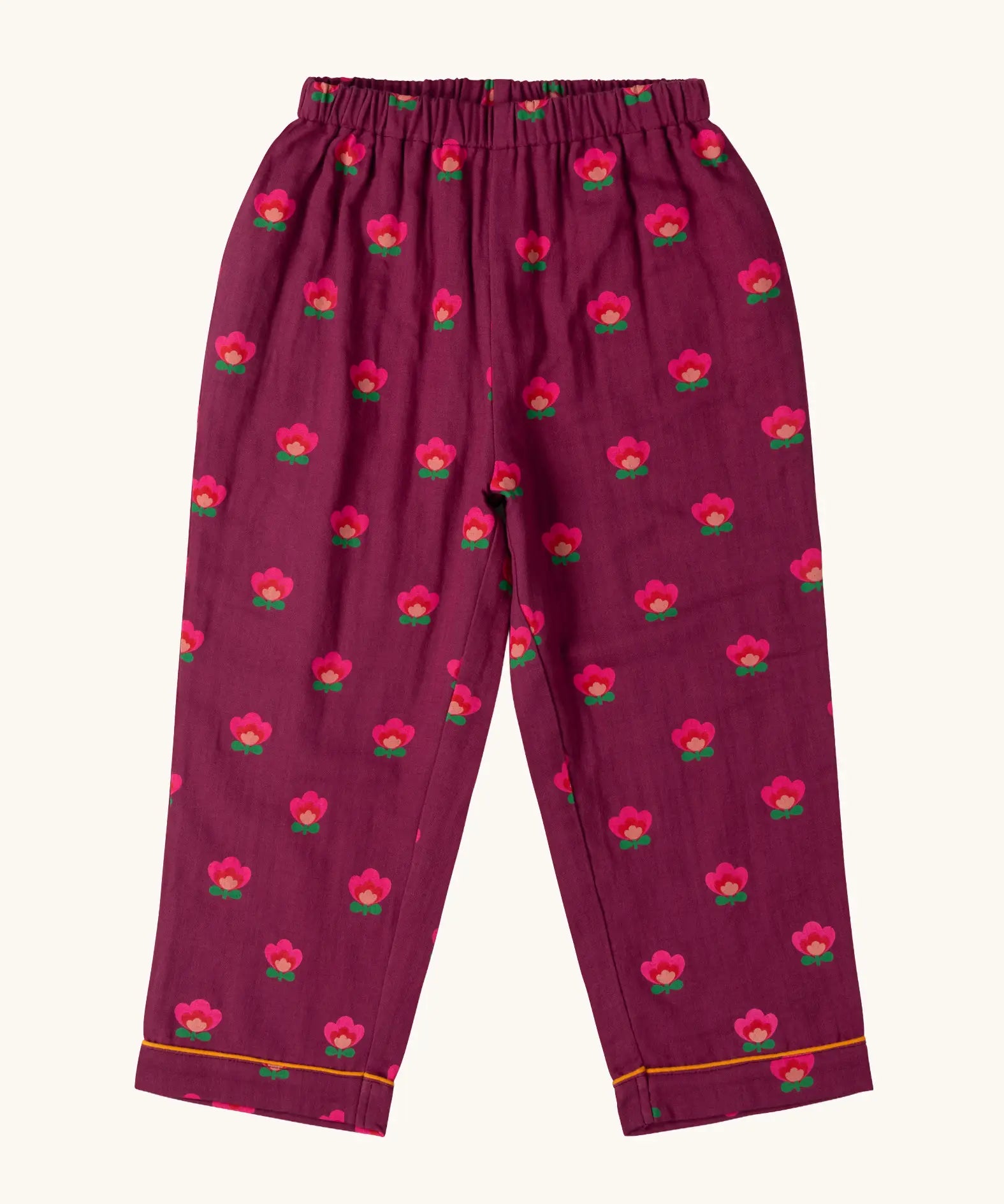 Trousers from the Little Green Radicals pink flowers print organic cotton classic purple pyjamas. Long sleeve button up top with matching trousers.