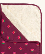 Close up of the fleece on the Little Green Radicals pink flowers organic cotton sherpa hooded baby blanket.