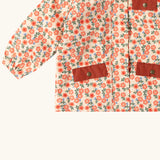 Close up of the pockets on the front of the Little Green Radicals pink petals recycled waterproof adventure lined Winter coat.