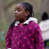 Child wearing a Little Green Radicals pink flowers purple organic cotton sherpa toasty coat.