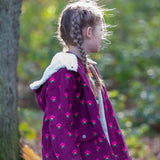 Child wearing a Little Green Radicals pink flowers purple organic cotton sherpa toasty coat.