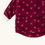 Close up of the pockets on the front of the Little Green Radicals pink flowers pattern purple organic cotton sherpa toasty coat.