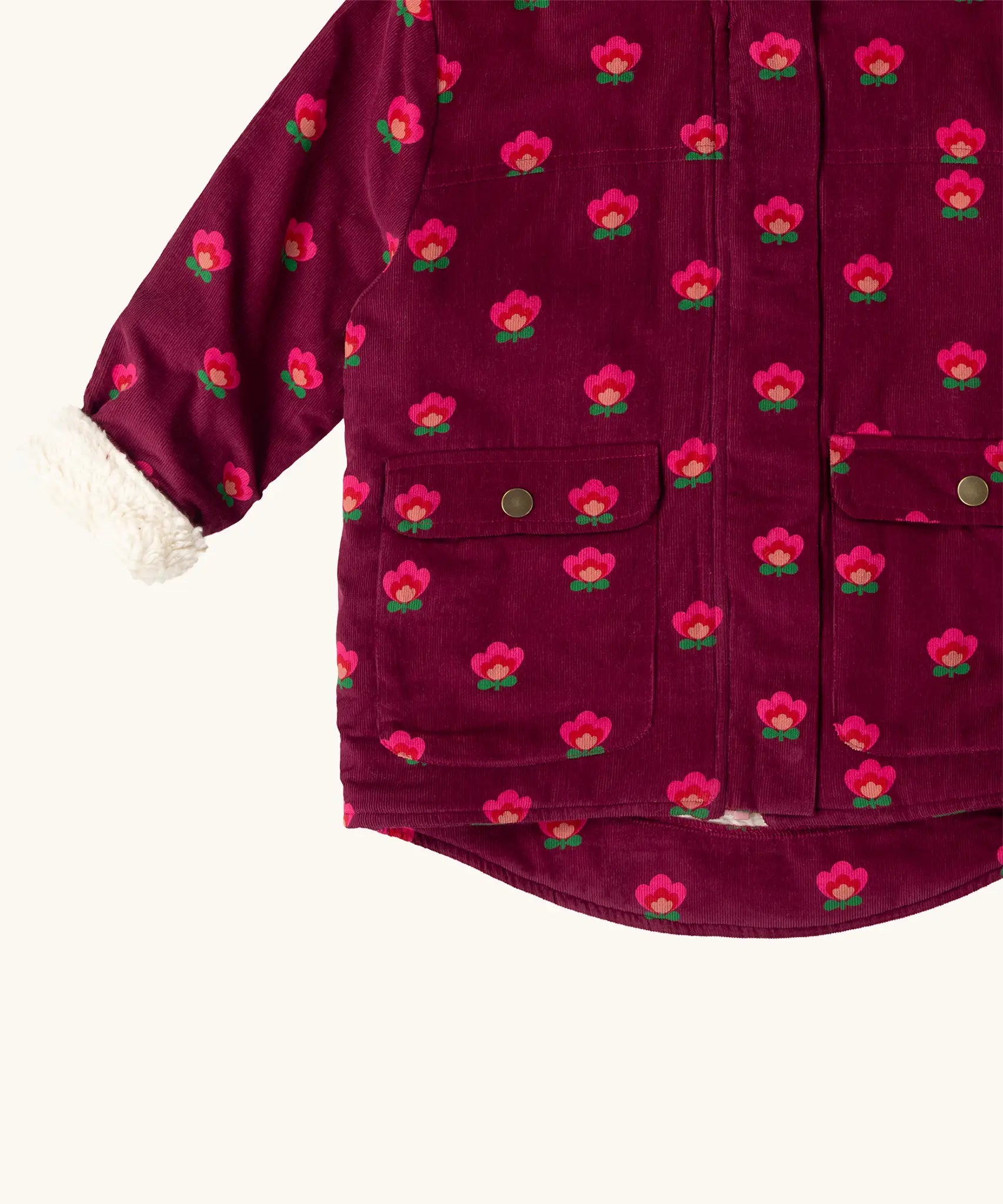 Close up of the pockets on the front of the Little Green Radicals pink flowers pattern purple organic cotton sherpa toasty coat.